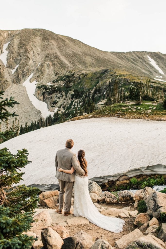 couple admiring the view in the mountains photographed by Colorado mountain wedding photographers