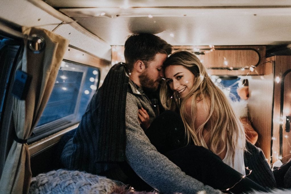 photo of couple kissing in a camper van taken by a Colorado engagement photographer