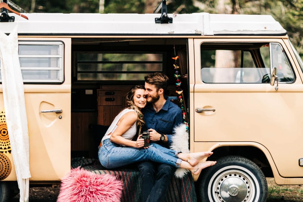 elopement vs wedding | eloping couple drinking coffee together in their camper van before their ceremony