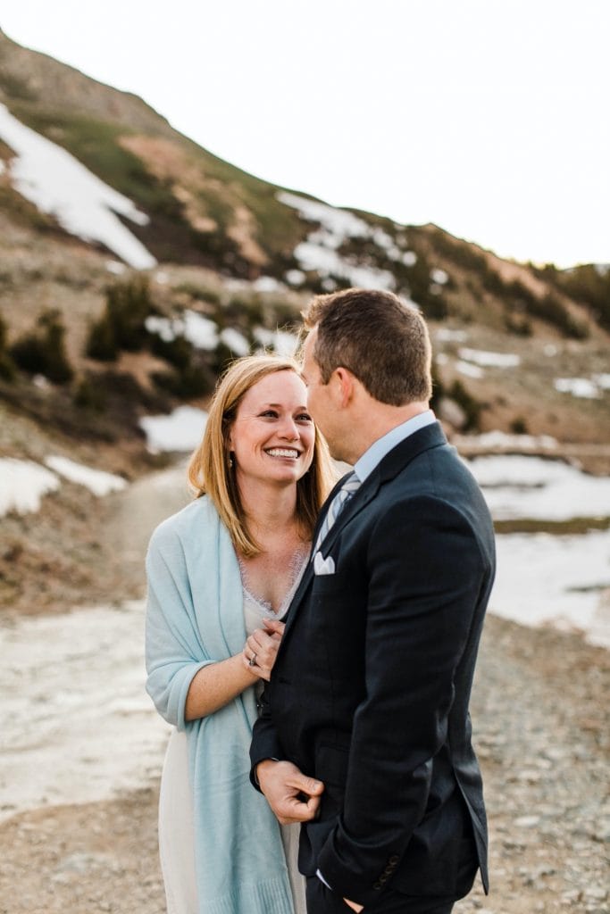 eloping couple snugging up together to stay warm during their sunrise Telluride elopement