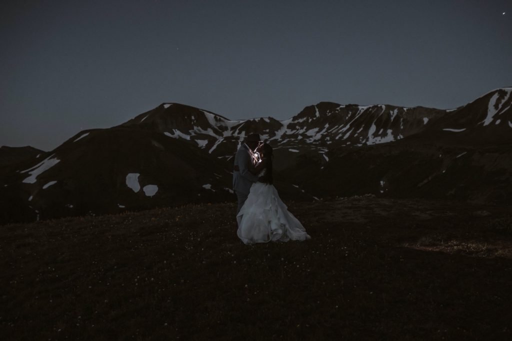 couple hiking in the dark for their Aspen Colorado elopement