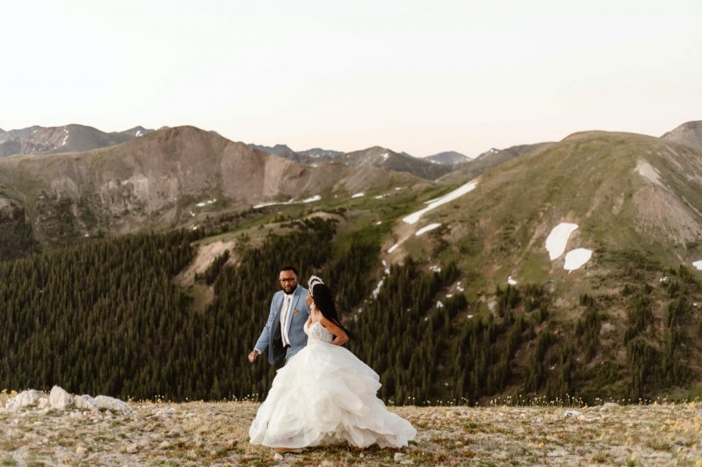 couple running through the mountains before their Aspen Colorado elopement