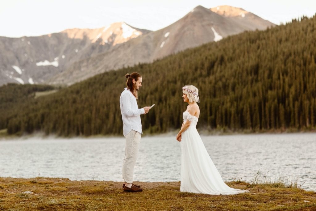 eloping couple reading their vows during their lake wedding ceremony in Colorado