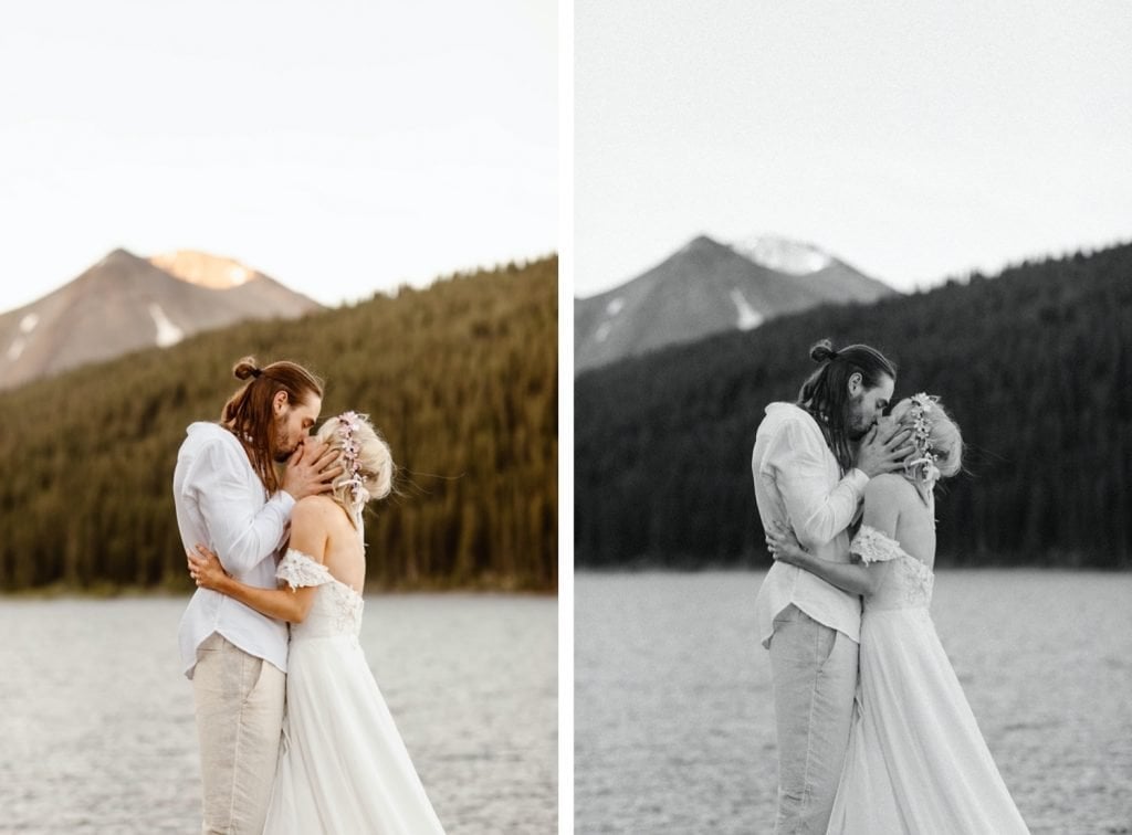 couple having their first kiss during their lake wedding ceremony in Colorado