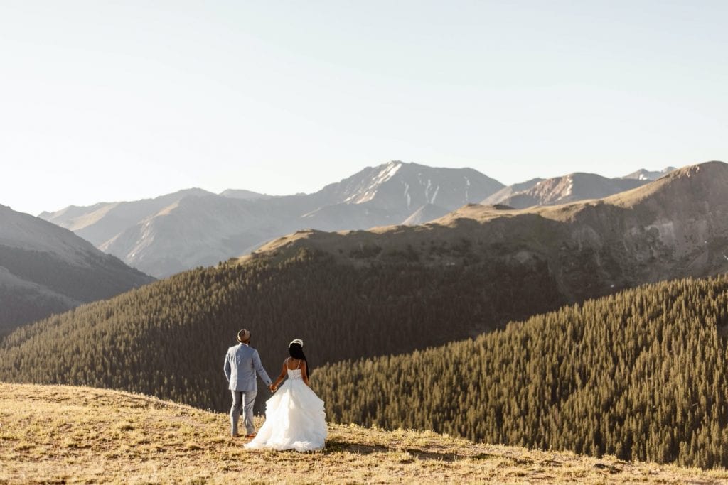 couple hiking through the mountains for their Aspen Colorado elopement