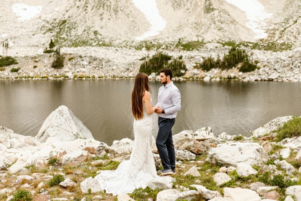 bride and groom sharing their vows during their Snowy Range Wyoming elopement by an alpine lake