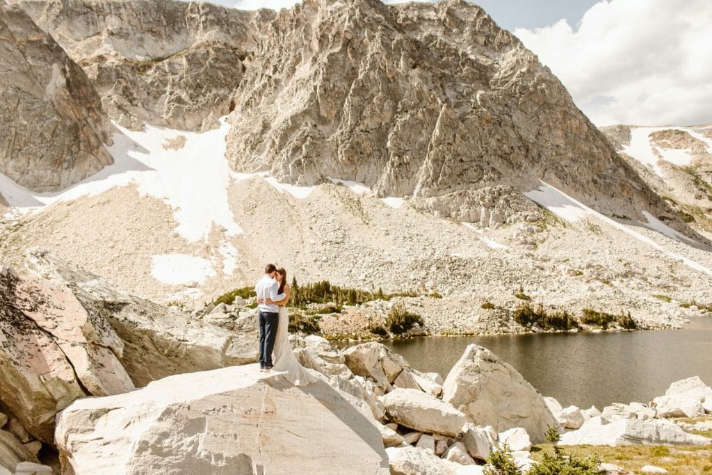 bride and groom adventuring in the mountains after their Snowy Range Wyoming elopement