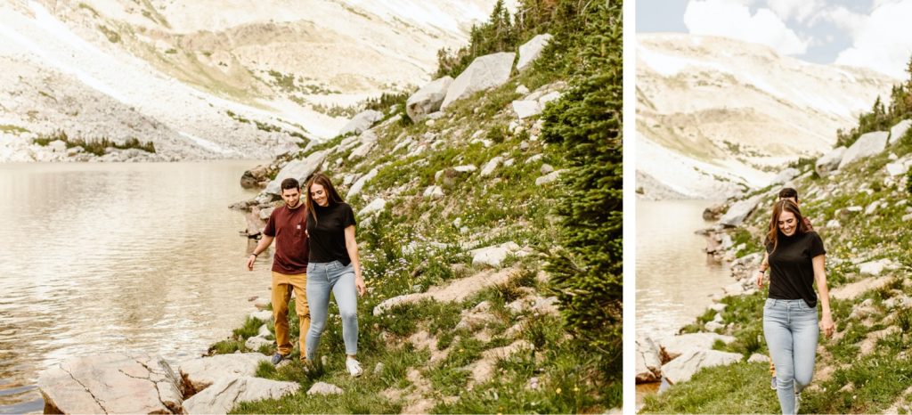 mountain engagement photos of a couple hiking by an alpine lake