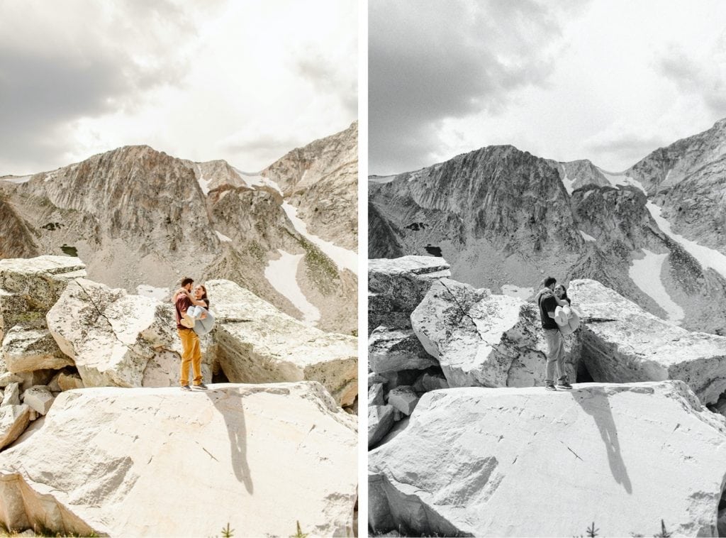 guy carrying girl through a boulder field on a mountaintop during their engagement session in Wyoming