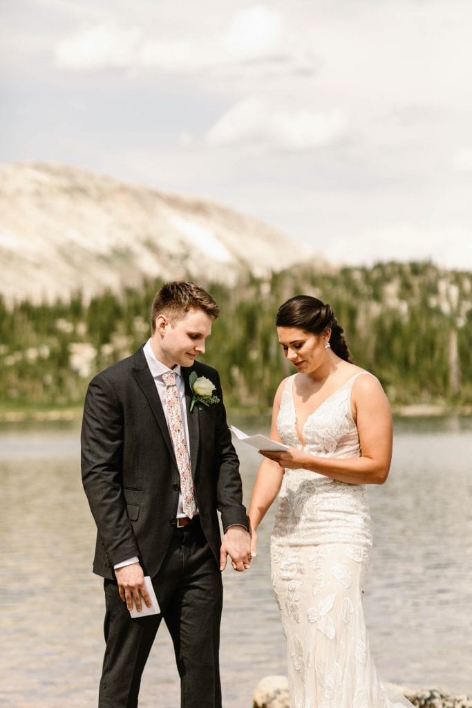 bride reading vows to groom during Wyoming wedding ceremony
