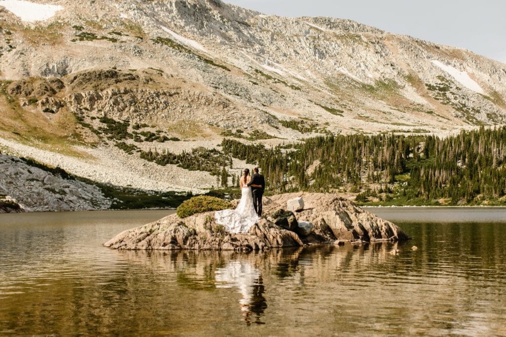 Wyoming wedding couple standing on an island in an alpine lake