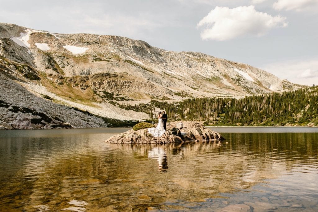 Wyoming wedding couple standing on an island in an alpine lake