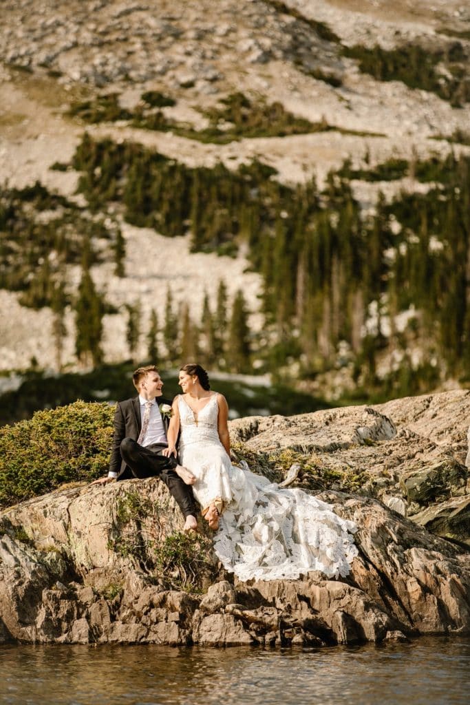 Wyoming wedding couple sitting on an island admiring the view