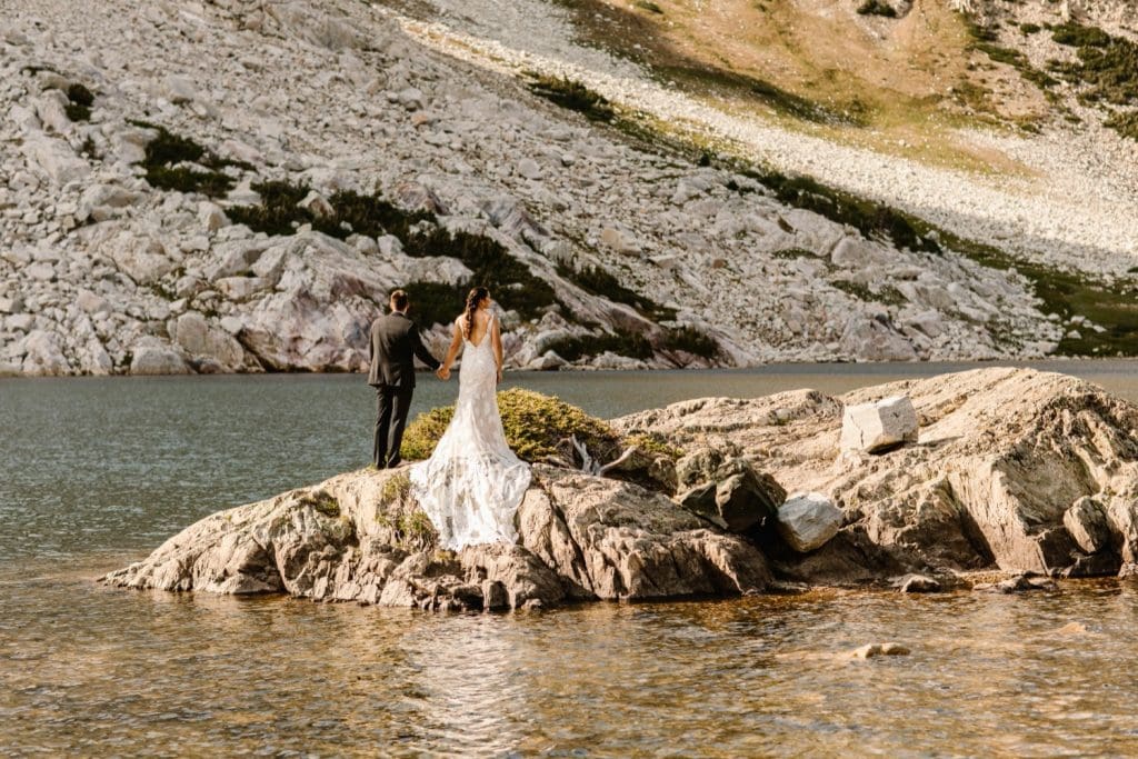 newly married couple adventuring on an alpine lake island after their small Wyoming wedding