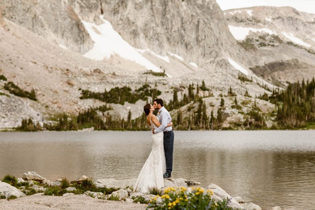 how much does it cost to elope | couple eloping in the mountains by an alpine lake