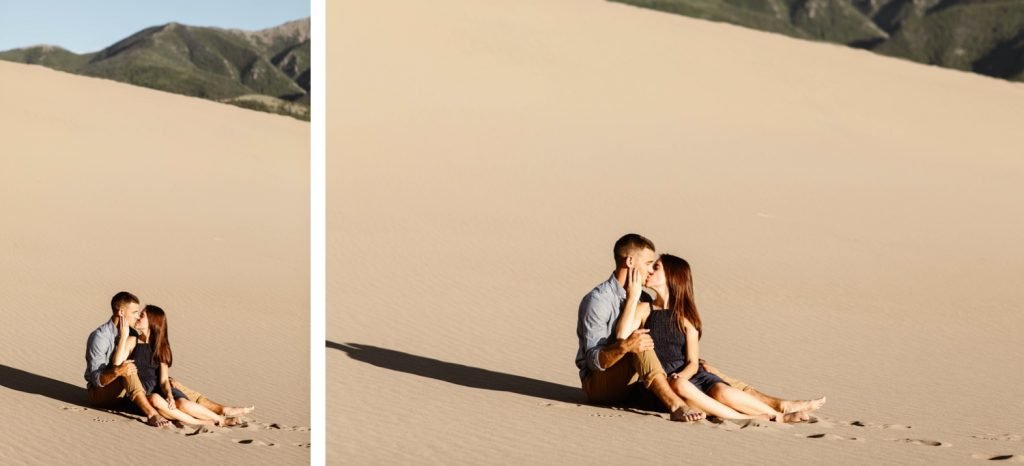 engaged couple snuggling up on the sand during their sand dunes engagement photos