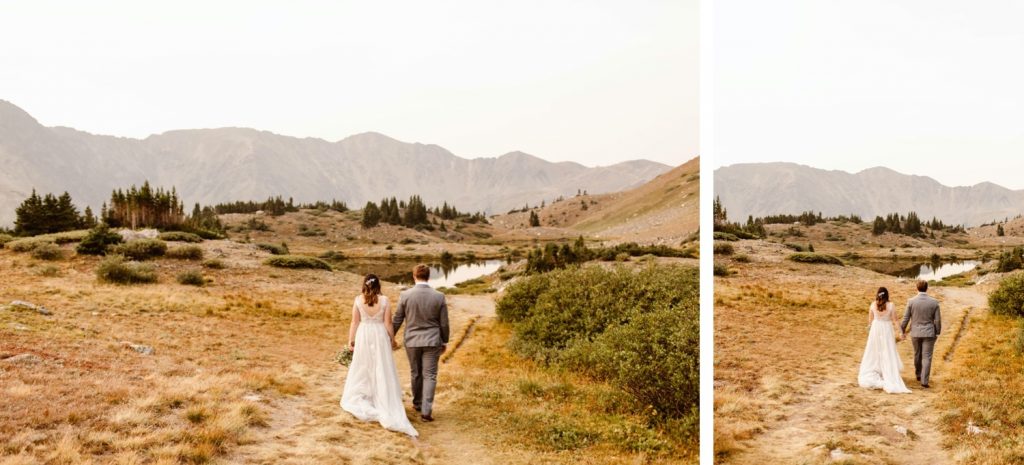 couple walking down a hiking trail together during their elopement