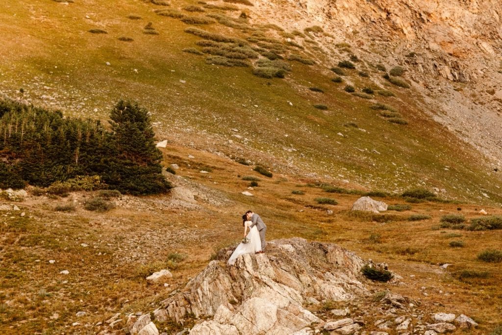 couple adventuring in the mountains after their sunrise elopement ceremony