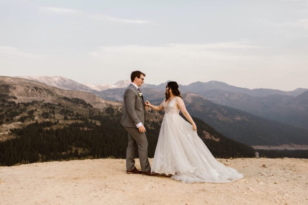 eloping couple sharing their first dance on the top of a mountain at sunrise