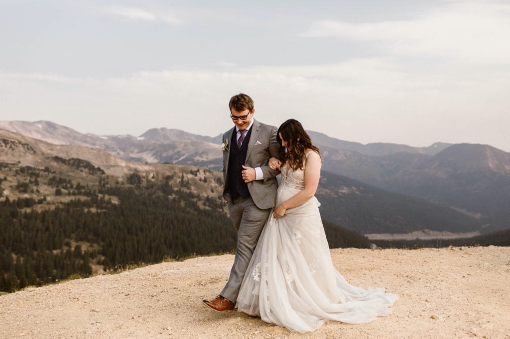 eloping couple sharing their first dance on the top of a mountain at sunrise