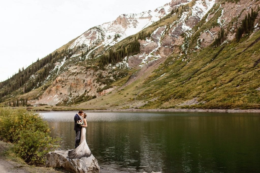 Crested Butte elopement photos of a couple standing lakeside