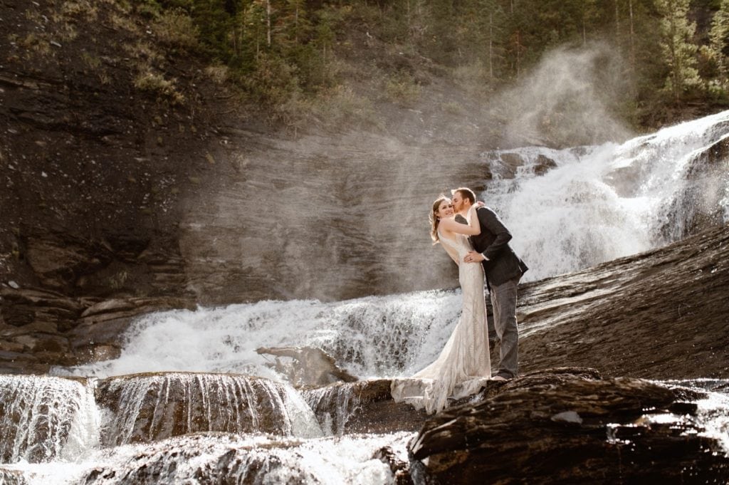 Crested Butte waterfall elopement photo of a newly married couple kissing