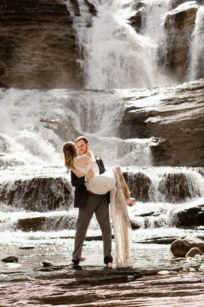 Crested Butte waterfall elopement photo of a newly married couple kissing