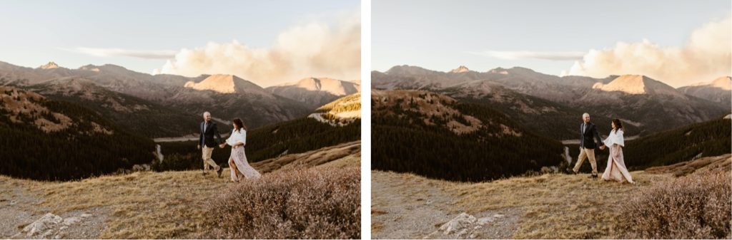 bride and groom walking hand in hand in the mountains while the smoke of a wildfire emerges from behind them