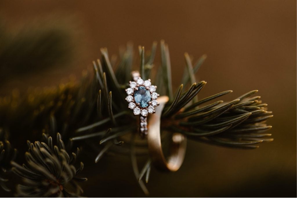 aquamarine engagement ring sitting on a tree branch