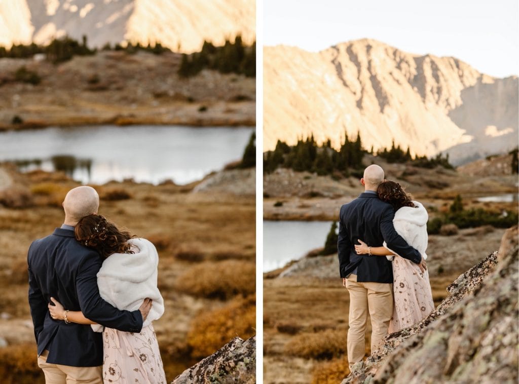 Colorado micro wedding couple standing together and admiring the alpenglow on the mountains at sunset