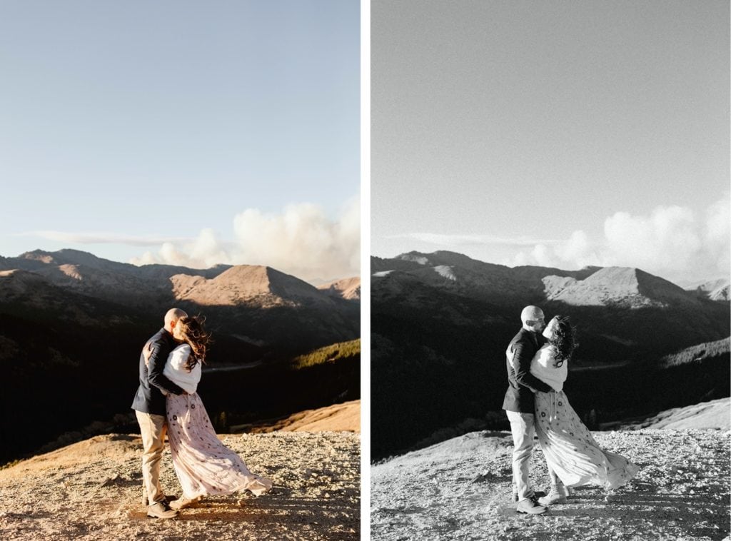 couple standing together on an overlook in the mountains while looking out a plume of wildfire smoke in Colorado