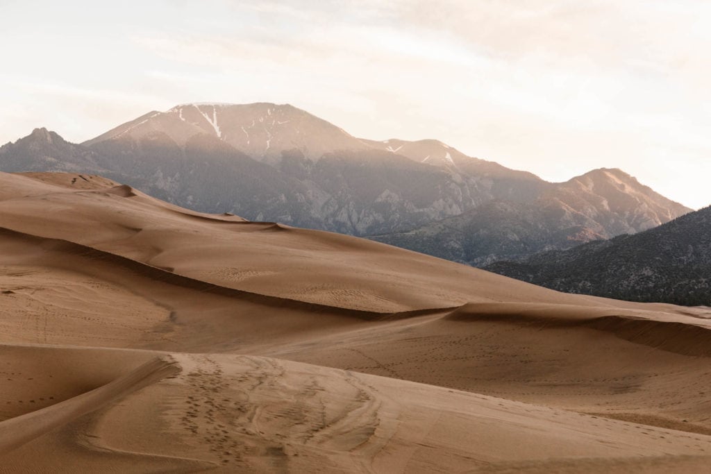 view of the sand dunes and Sangre de Cristo mountains during a Colorado road trip itinerary stop