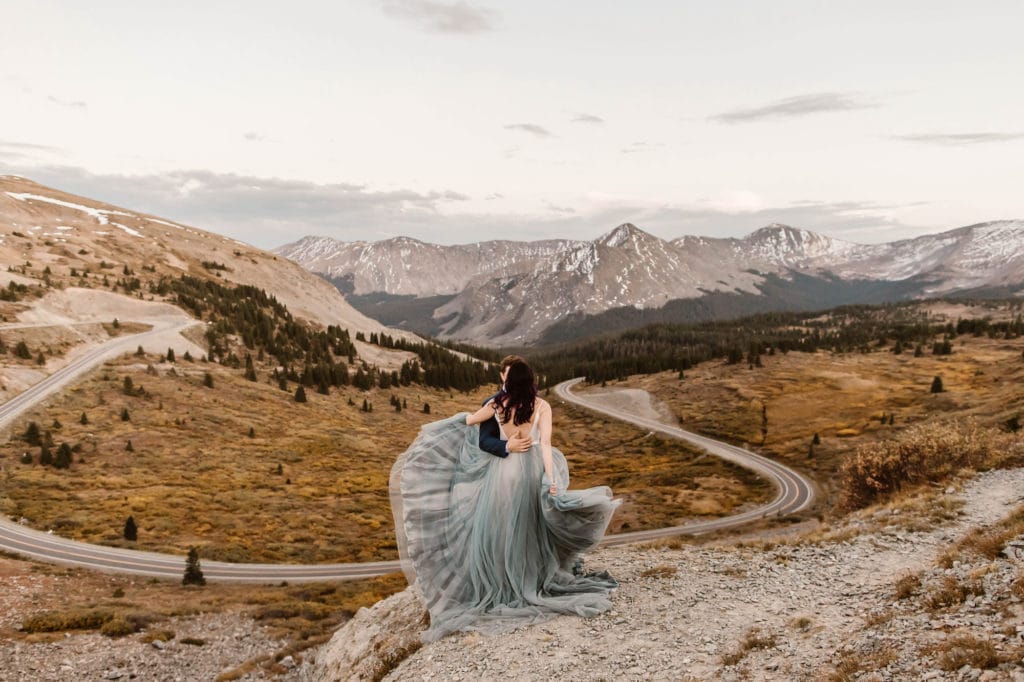 two toned goddess wedding dress hand painted blue for an elopement in the mountains