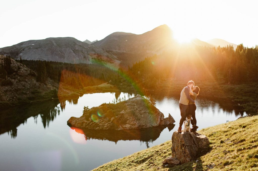 couple standing by an alpine lake in Colorado during the best time to visit the high country