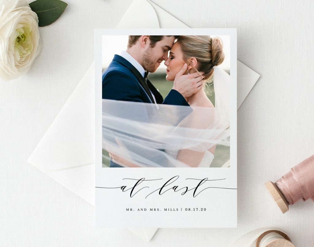 classy calligraphy elopement announcement card with writing on the front that says "at last"