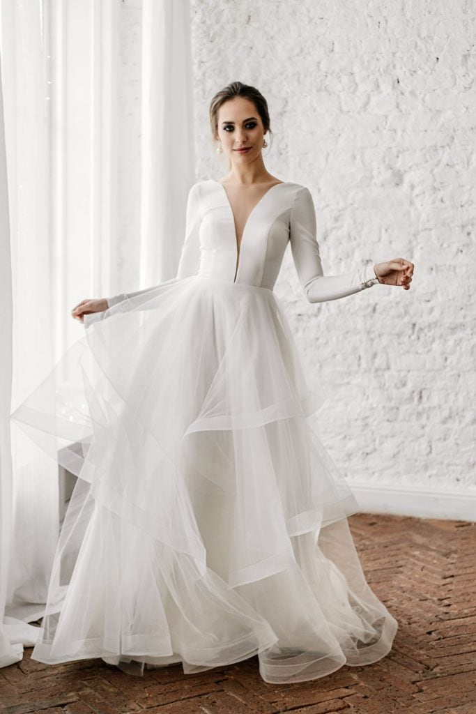 open back simple layered tulle long sleeve elopement dress with a thin and deep plunging neckline