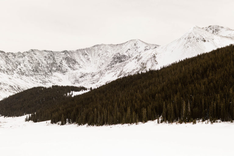 snow covered mountains at Clinton Gulch Dam Reservoir in March
