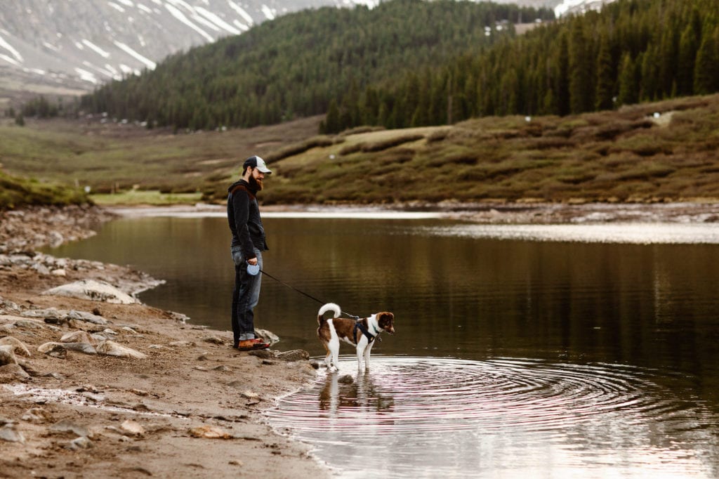 man and his dog standing by the water at Clinton Gulch Dam Reservoir