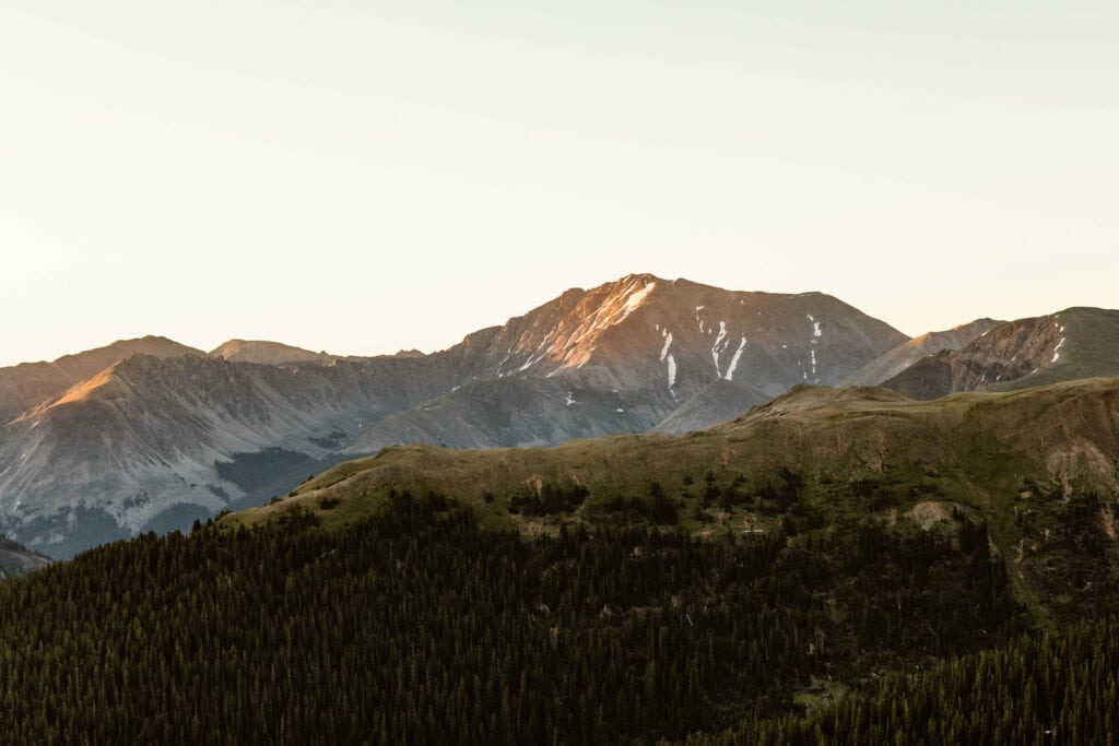 maroon alpenglow on the mountains as seen from Independence Pass Colorado at sunrise