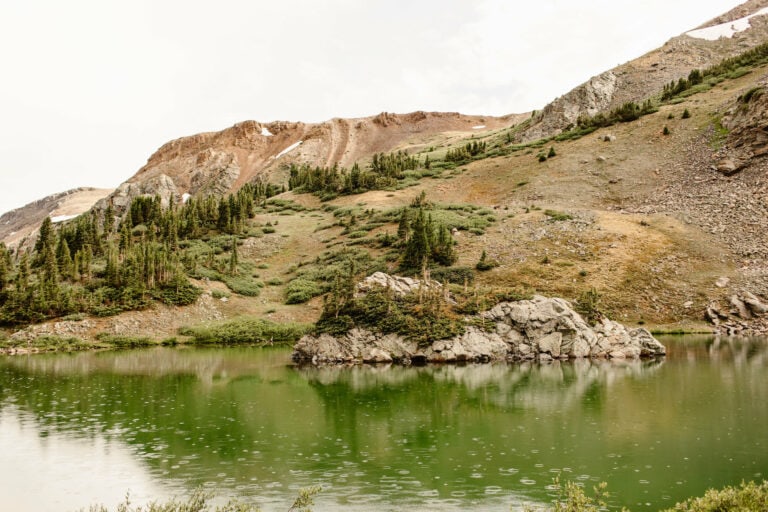 green alpine lake on a drizzly day on Cottonwood Pass Colorado