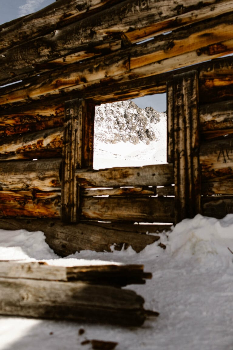 mining cabin ruins covered in snow along Mayflower Gulch Trail during a Colorado winter