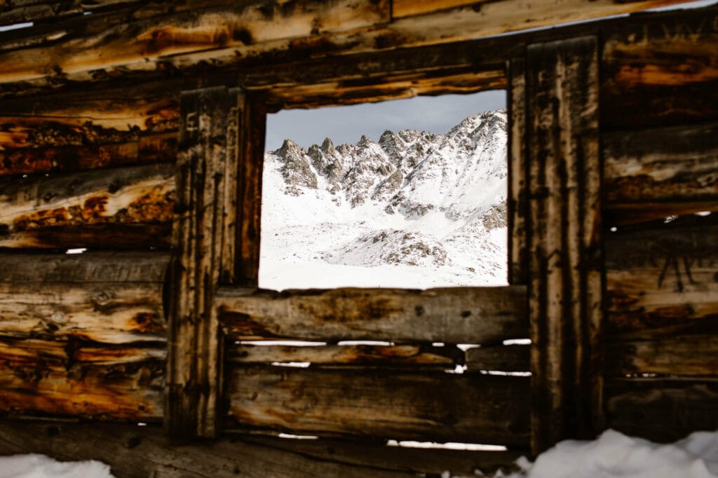 mining cabin ruins covered in snow along Mayflower Gulch Trail during a Colorado winter