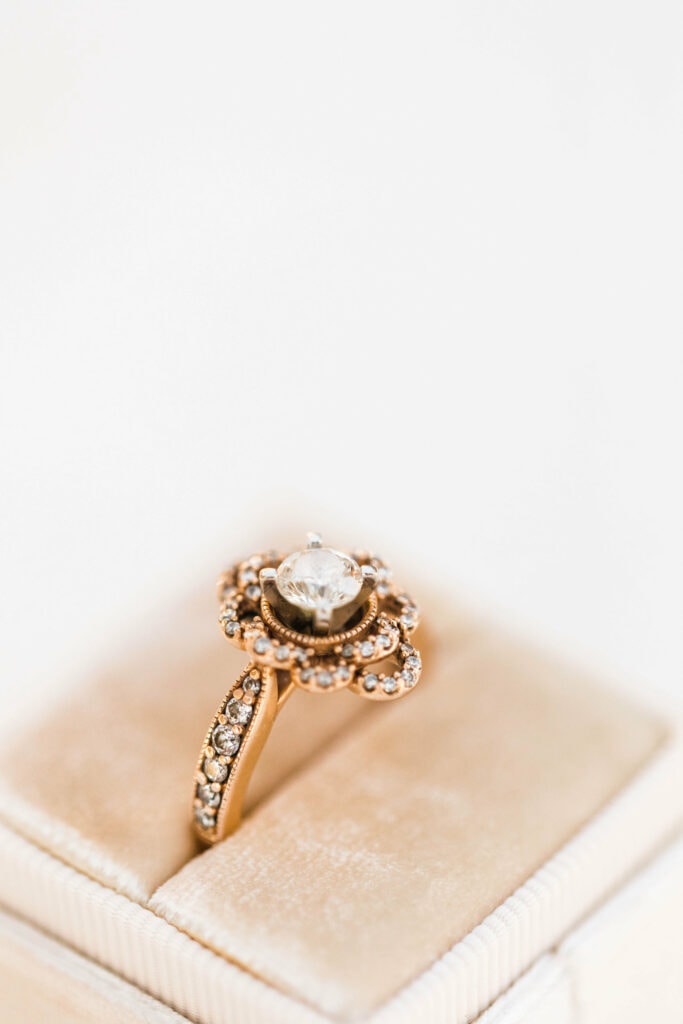 rose gold vintage engagement ring sitting in a pink velvet unique wedding ring box