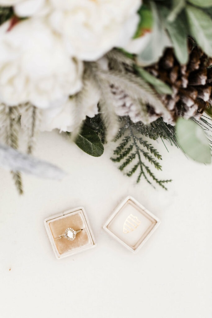 neutral velvet unique wedding ring box holding a white gold diamond engagement ring