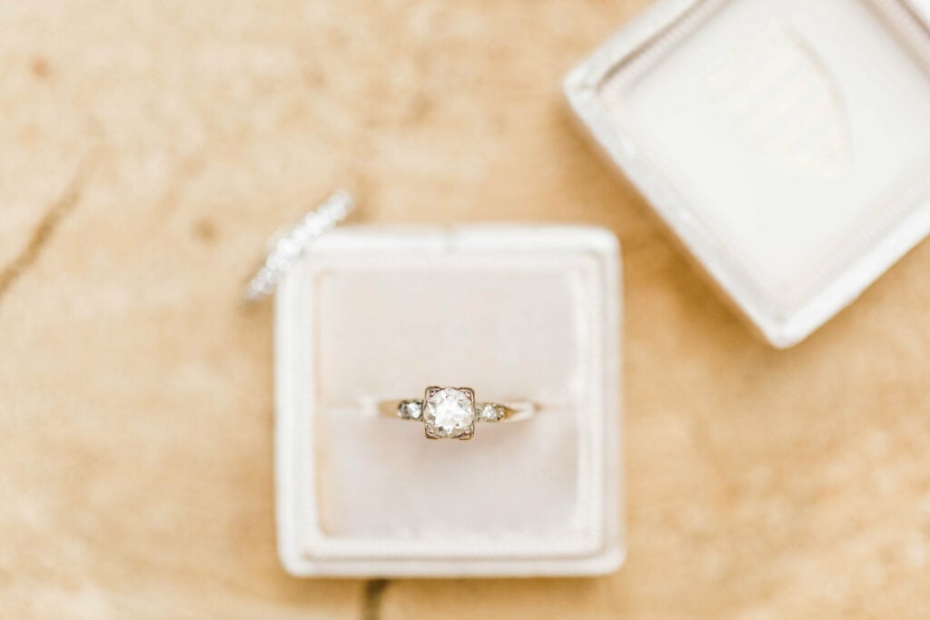 vintage diamond engagement ring sitting in an off white velvet unique wedding ring box from the Mrs Box