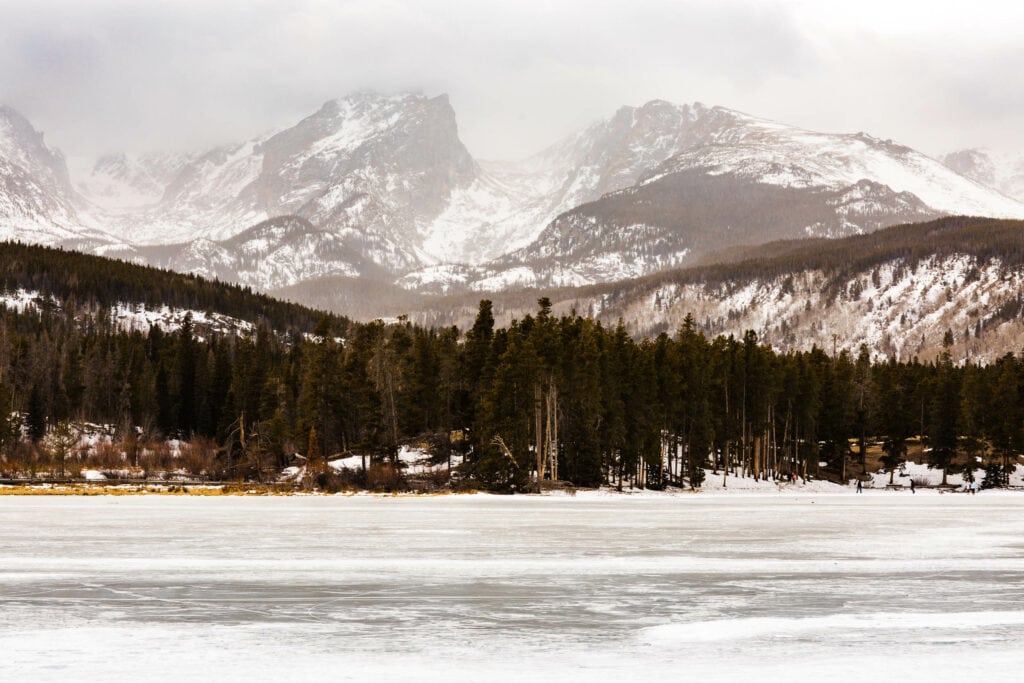 views of a frozen Sprague Lake that can be seen in the winter when living in Colorado