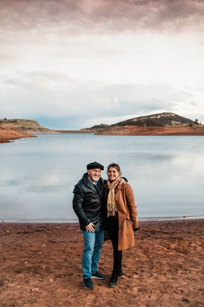 retired couple standing by a lake in Colorado