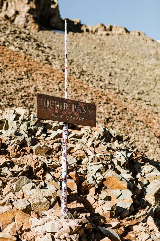 metal elevation sign at the summit of Ophir Pass CO stating that you are at 11789 feet