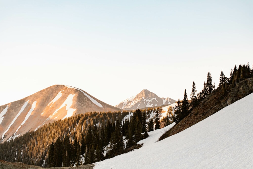 snowfield in front of the mountains at sunrise on Ophir Pass in Colorado