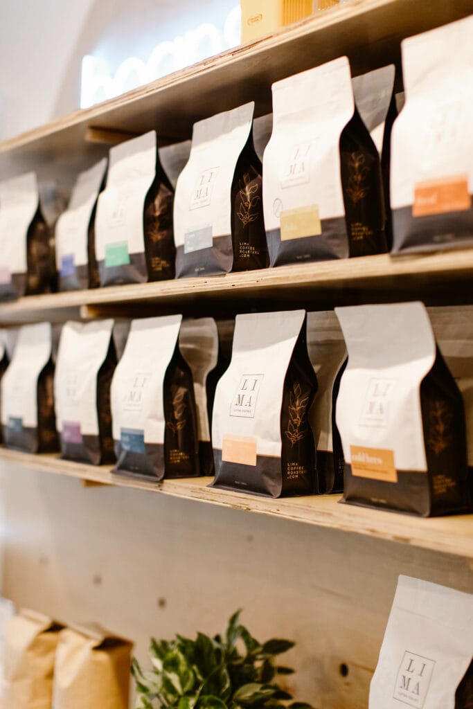 bags of roasted beans on a wooden shelf in Lima Coffee Roasters coffee shop in Fort Collins